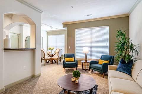 a living room with a couch and chairs and a table